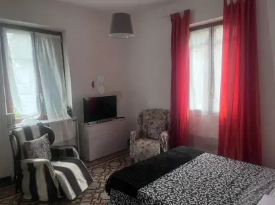 a bedroom with a bed and a chair and a television at Ranieri casa vacanze in Rome