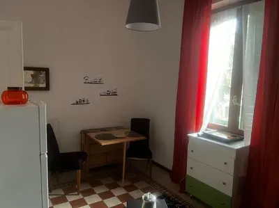 a small kitchen with a table and a window at Ranieri casa vacanze in Rome