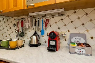 a kitchen counter with a mixer and utensils at Colosseum Dream Apartment in Rome
