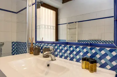 a bathroom with a sink and a mirror at Colosseum Dream Apartment in Rome