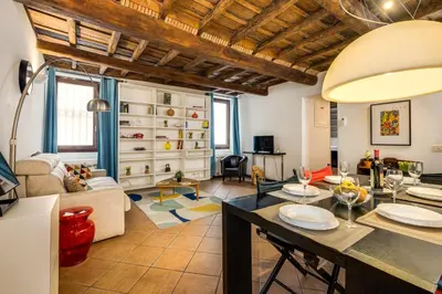 a kitchen and living room with a table and chairs at Colosseum Dream Apartment in Rome