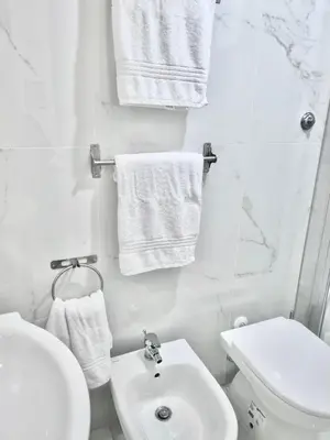 a bathroom with a sink and a toilet and towels at Domus Euclide in Rome