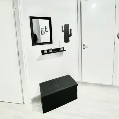 a black stool in front of a mirror on a wall at Domus Euclide in Rome