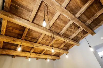 a wooden ceiling with lights in a room at Videnda Colosseo in Rome