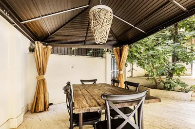 an outdoor dining room with a wooden table and chairs at Videnda Colosseo in Rome