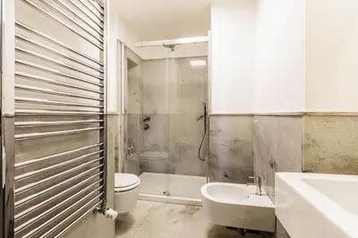 a bathroom with a toilet and a sink and a shower at Videnda Colosseo in Rome