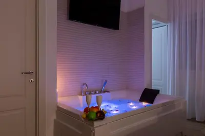 a bath tub with a sink with fruit in it at FARNESINA SUITE in Rome