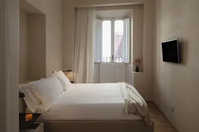 a bedroom with a white bed and a window at P10 DESIGN in Rome