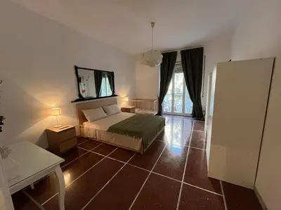 a bedroom with a bed and a mirror on the wall at Dolce Vita Suites in Rome