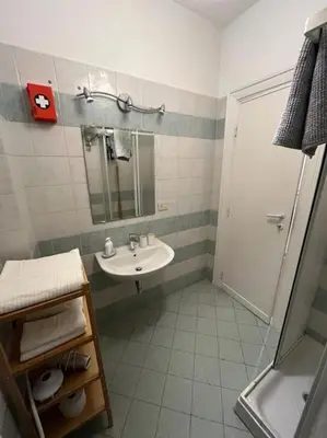 a white bathroom with a sink and a shower at Dolce Vita Suites in Rome
