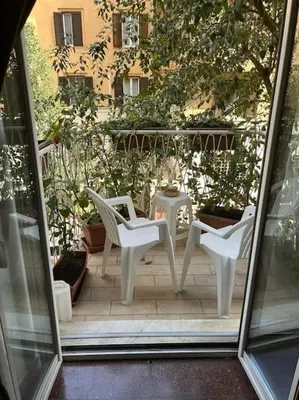 two white chairs and a table on a patio at Dolce Vita Suites in Rome