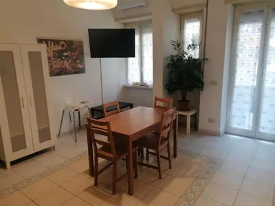 a dining room with a wooden table and chairs at Dolce Vita Suites in Rome