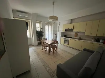 a kitchen and dining room with a table and chairs at Dolce Vita Suites in Rome