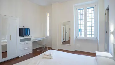 a white bedroom with a bed and a tv at EasyTopStay - Crescenzio Elegant Apartment in Rome