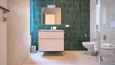 a bathroom with a toilet and a sink and a mirror at EasyTopStay - Crescenzio Elegant Apartment in Rome