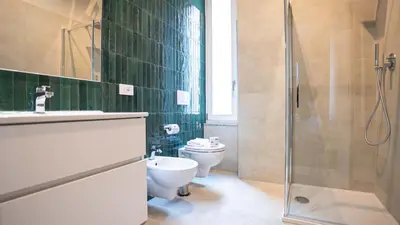 a bathroom with a toilet and a glass shower at EasyTopStay - Crescenzio Elegant Apartment in Rome