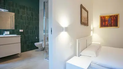 a bathroom with a toilet and a sink and a mirror at EasyTopStay - Crescenzio Elegant Apartment in Rome