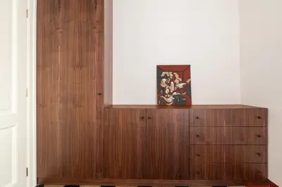 a wooden cabinet with a vase on top of it at Welcome to Vatican in Rome