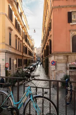 two bikes parked on a street with buildings at Welcome to Vatican in Rome