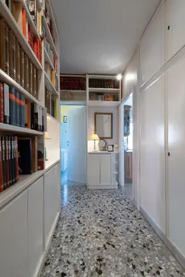 a hallway with white walls and bookshelves at In Vacanza dai Nonni in Rome