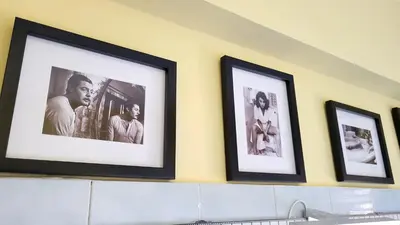 a row of framed pictures on a wall at In Vacanza dai Nonni in Rome
