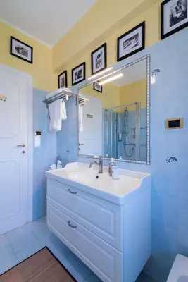 a bathroom with a white sink and a mirror at In Vacanza dai Nonni in Rome
