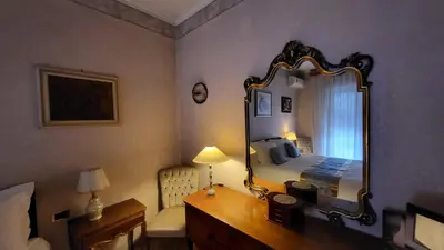 a bedroom with a bed and a large mirror at In Vacanza dai Nonni in Rome