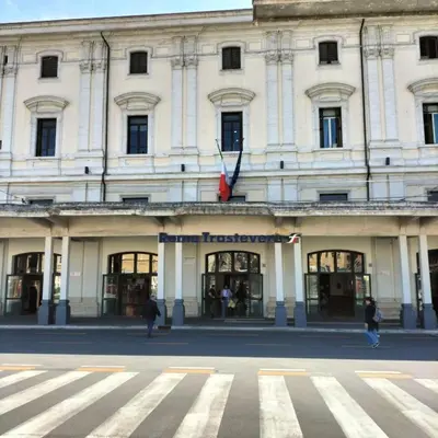 a large white building with people walking in front of it at Nic trastevere house in Rome