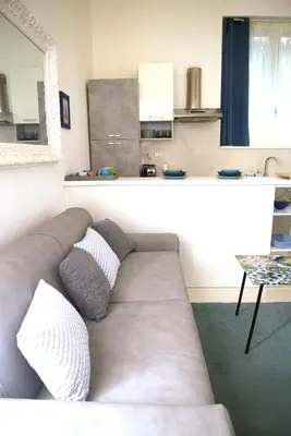 a couch with two pillows sitting in a living room at Residenza Santi ai Monti in Rome