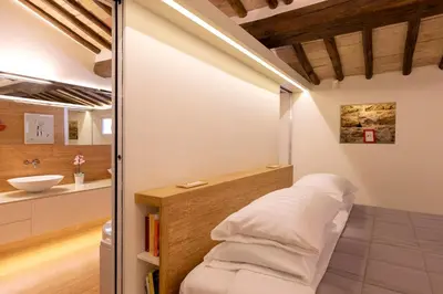 a bathroom with a bed and a sink at Restart Accommodations Moro in Rome