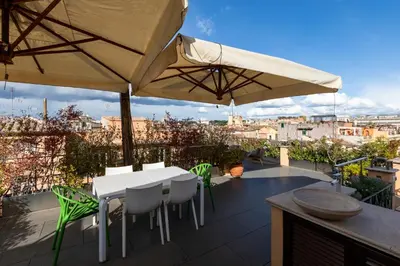 a balcony with white tables and chairs and umbrellas at Restart Accommodations Moro in Rome