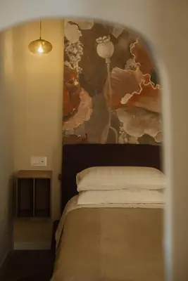 a bedroom with a bed with a painting on the wall at Restart Accommodations Tritone in Rome