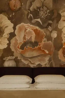 a bedroom with a painting of flowers on the wall at Restart Accommodations Tritone in Rome
