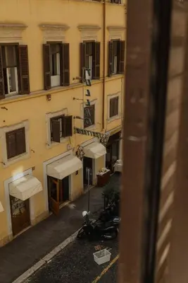 a view from a window of a building with a motorcycle at Restart Accommodations Tritone in Rome