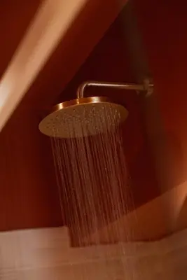 a shower with a hose attached to a wall at Restart Accommodations Tritone in Rome