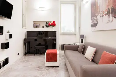 a living room with a couch and a piano at Restart Accommodations Nettuno in Rome