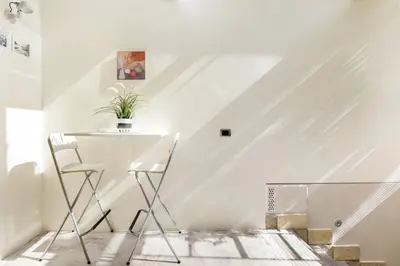 a white room with a table and two chairs at Restart Accommodations Nettuno in Rome