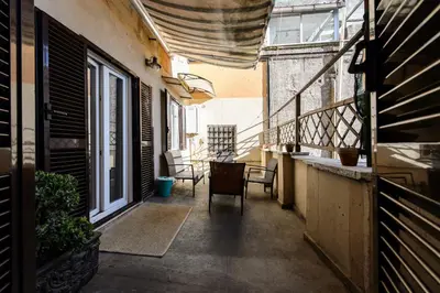 a balcony with a table and chairs in a building at Guesthouse o Affittacamere Casa Barberini in Rome