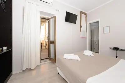 a bedroom with a bed with two towels on it at Guesthouse o Affittacamere Casa Barberini in Rome