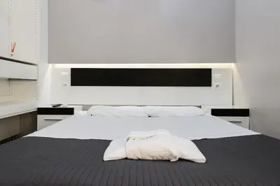a bedroom with a large white bed with a towel on it at Guesthouse o Affittacamere Casa Barberini in Rome