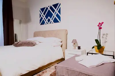 a bedroom with two beds and a table with a lamp at Comfort in Centro, benvenuti nella Cosy House in Rome
