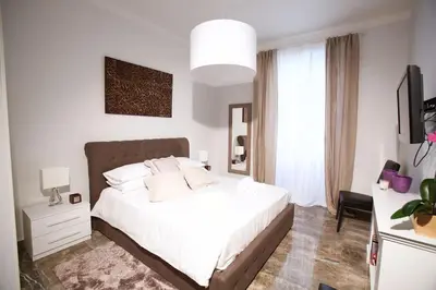 a bedroom with a white bed and a large window at Comfort in Centro, benvenuti nella Cosy House in Rome