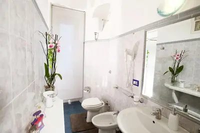 a white bathroom with a toilet and a sink at Comfort in Centro, benvenuti nella Cosy House in Rome