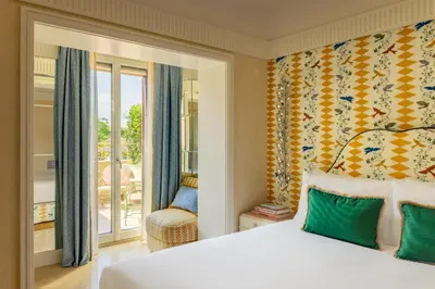 a bedroom with a bed and a window and a chair at Casa Monti Roma in Rome