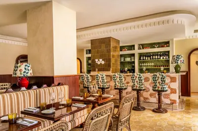 a restaurant with tables and chairs and a bar at Casa Monti Roma in Rome