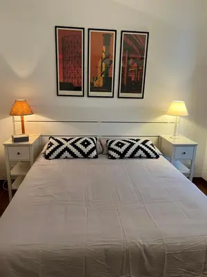 a bedroom with a large bed with two pillows at La casa di Monica appartamento Ostiense Roma in Rome