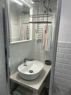 a bathroom with a white sink and a mirror at La casa di Monica appartamento Ostiense Roma in Rome