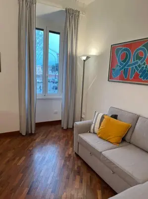 a living room with a couch and a window at La casa di Monica appartamento Ostiense Roma in Rome