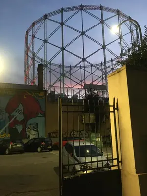 a gate in front of a building with a mural at La casa di Monica appartamento Ostiense Roma in Rome