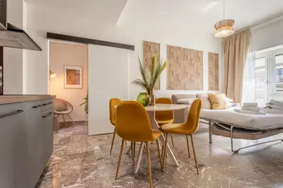 a living room with a table and chairs and a couch at Cornelia cozy home in Rome